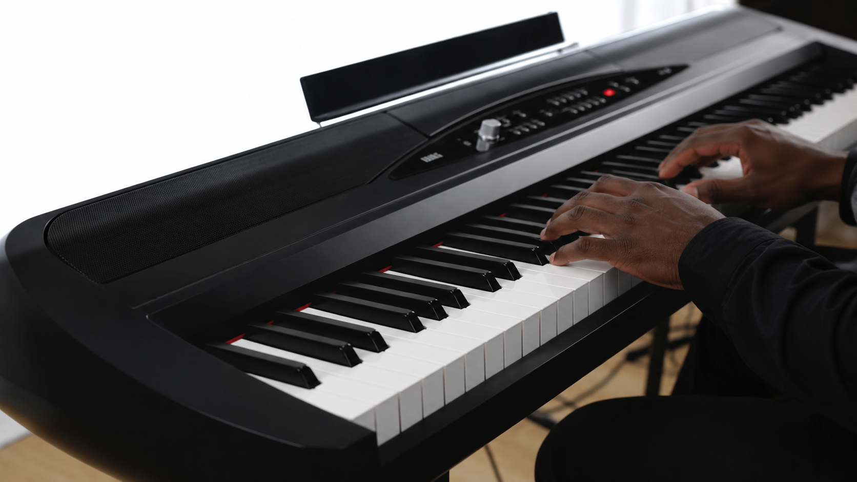 Person playing a Korg Piano